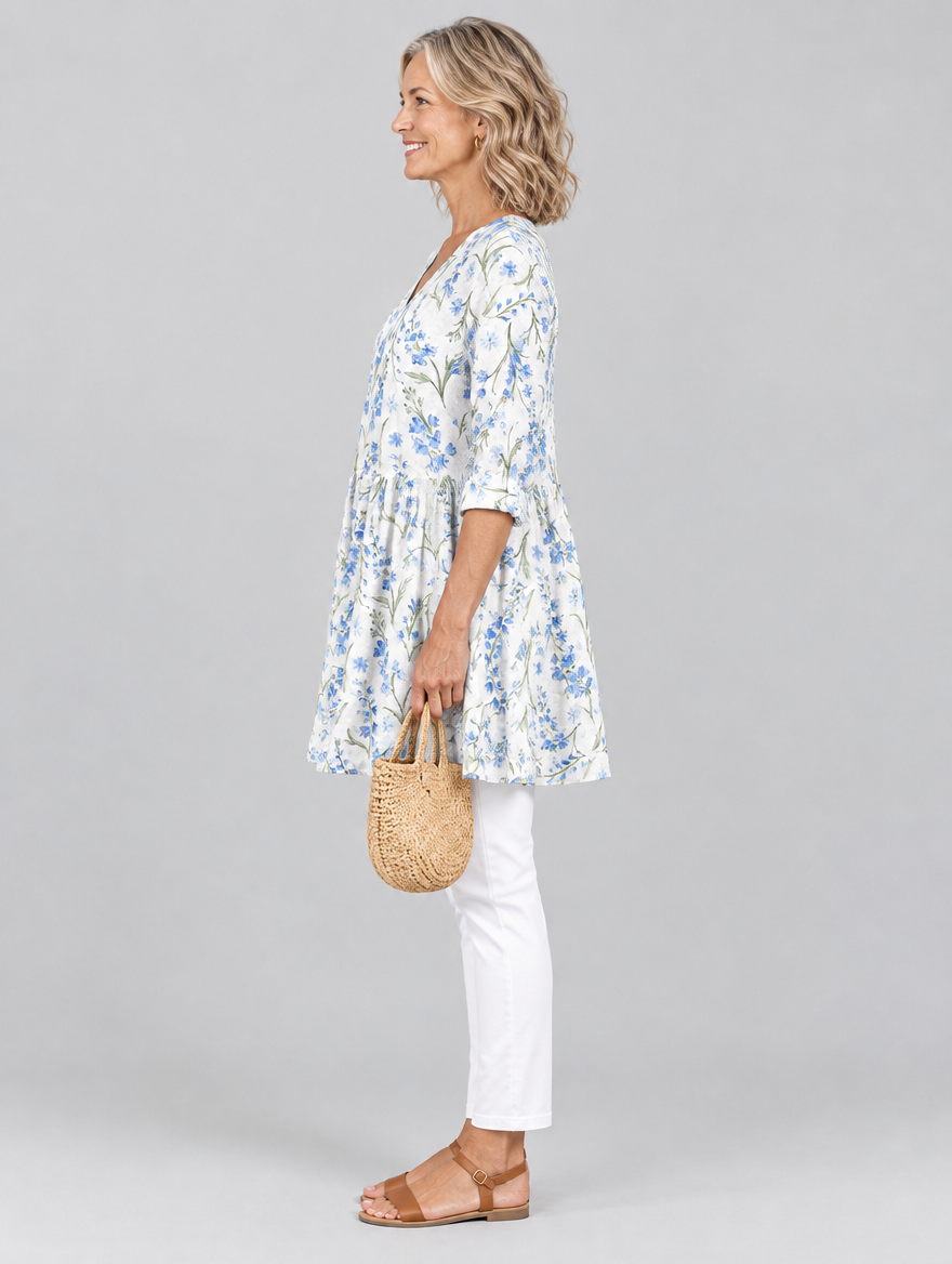 Lenora long blouse in white with cornflower blue wildflower print, side view showing the relaxed fit