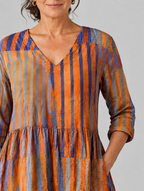 Amaia long blouse in burnt orange and violet painted stripe print, close up of print and neckline