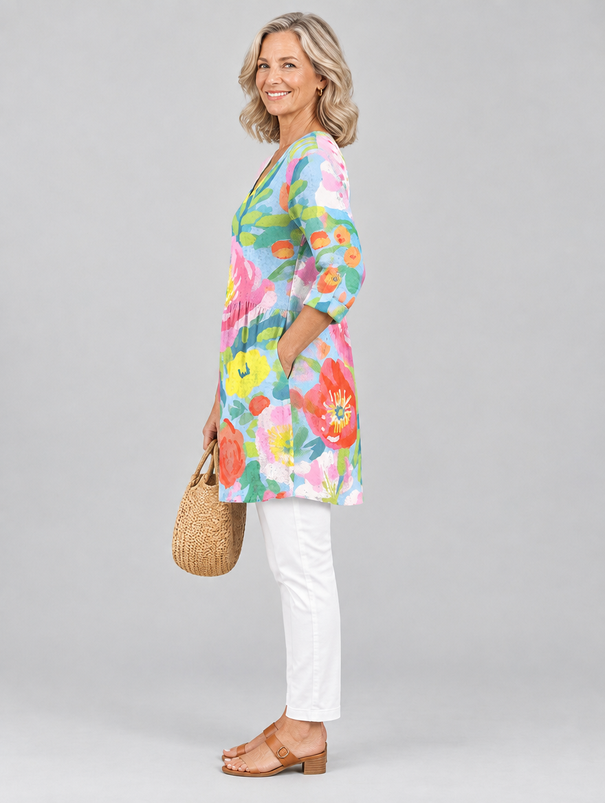 Valerie long blouse in pastel watercolour poppy print on sky blue, side view showing the relaxed fit