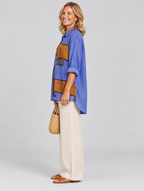 Anne relaxed tunic in periwinkle blue sausage dog print, side view showing the relaxed fit