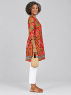 Marcy long blouse in tangerine and red floral print, side view showing the relaxed fit