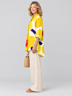 Haisley relaxed tunic in sunflower yellow retro poppy print, side view showing the relaxed fit