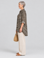 Sharon relaxed tunic in sand and black swirl print, side view showing the relaxed fit