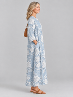 Avery printed maxi dress in blue with raised white floral print, side view