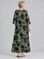 Scarlett printed maxi dress in sage green with black floral print, back view