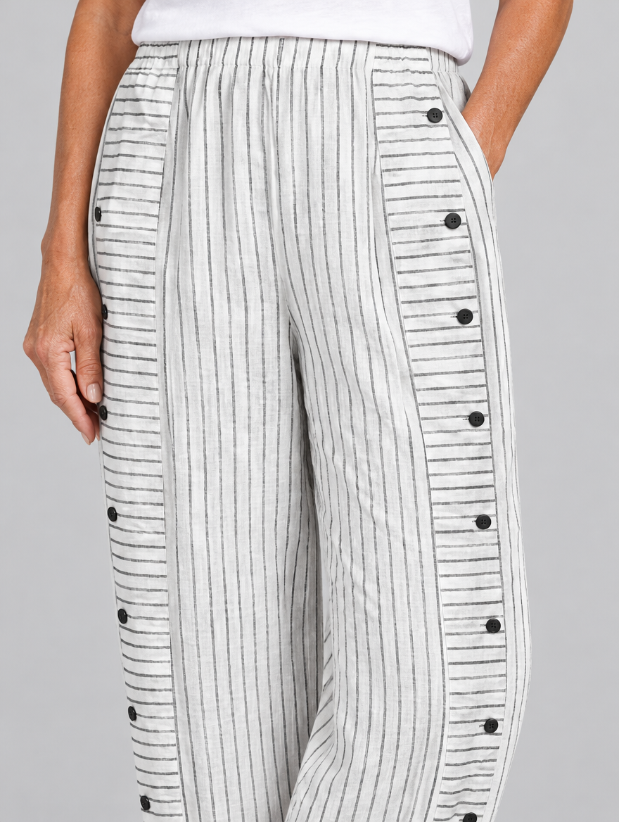 Inaya button trousers in white stripe, close up of waistband, side buttons and fabric