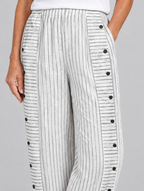 Inaya button trousers in white stripe, close up of waistband, side buttons and fabric