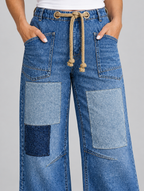 Rosita patchwork jeans in mid blue, close up of rope drawstring, pockets and patches