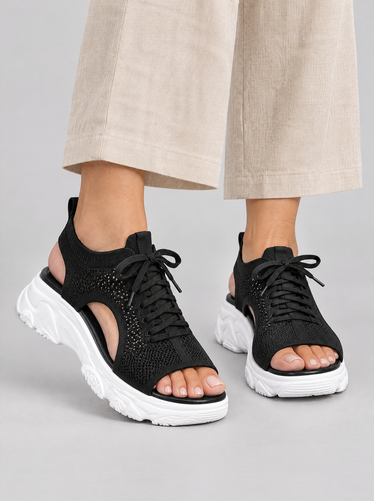 Maria sandals in black, worn with beige linen trousers