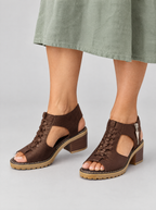 Ouida sandals in brown, worn with a sage green linen dress