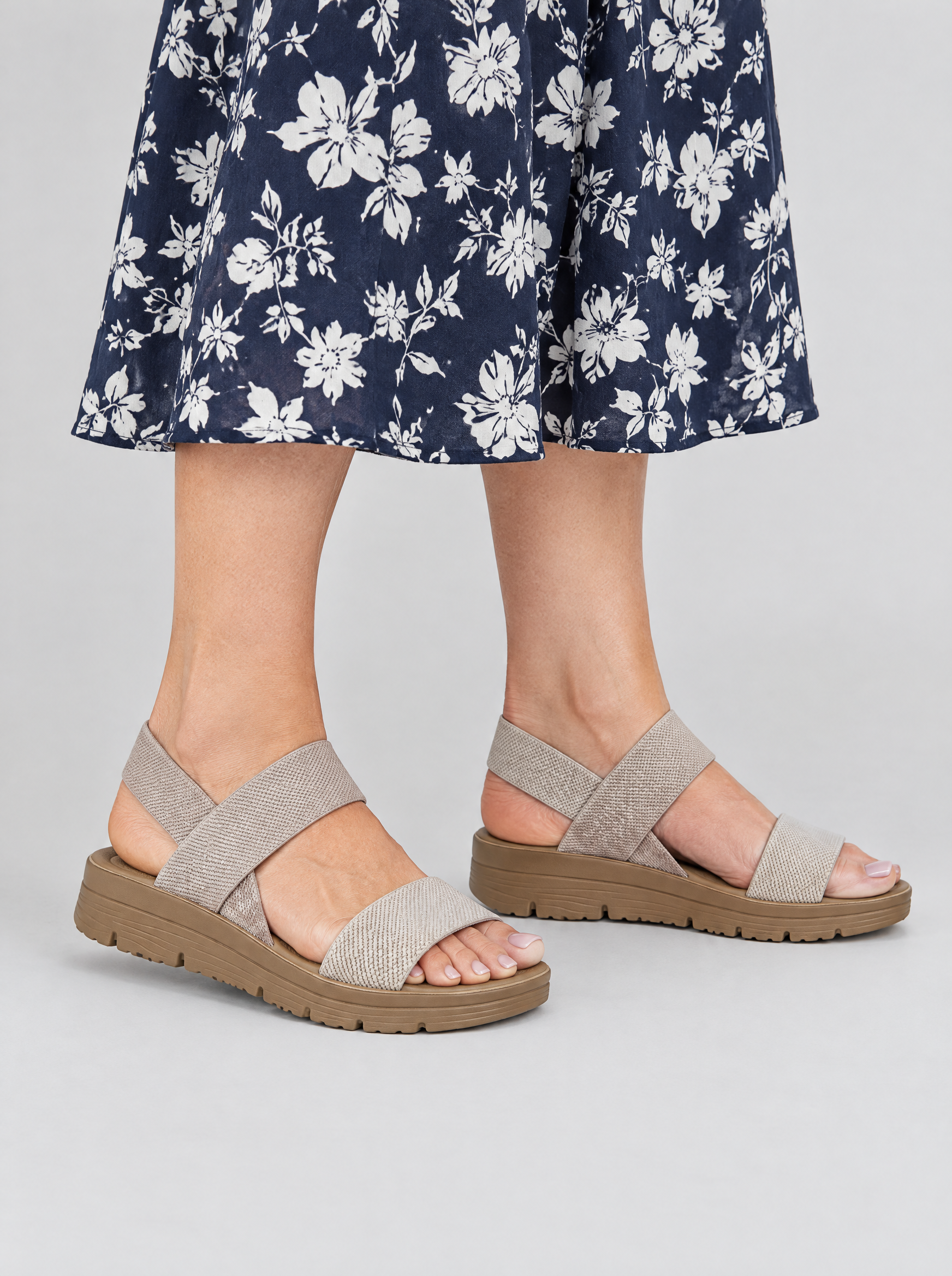 Ailany sandals in khaki, worn with a navy and white floral print midi dress