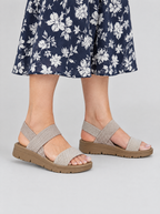 Ailany sandals in khaki, worn with a navy and white floral print midi dress