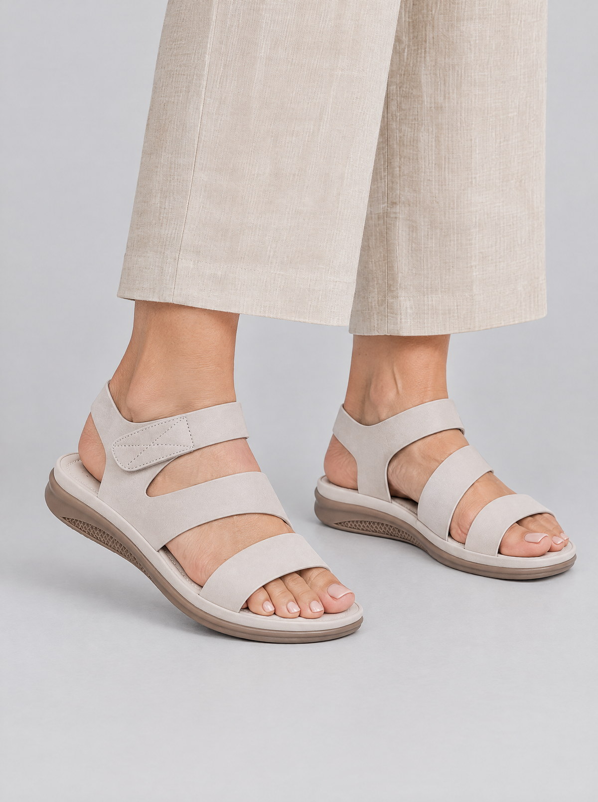 Alessandra sandals in beige, worn with neat beige linen wide leg trousers