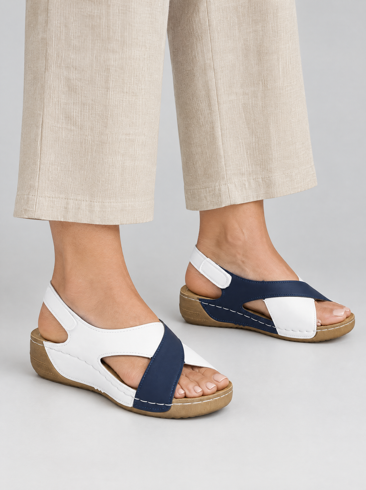 Nigella sandals in blue, worn with neat beige linen wide leg trousers