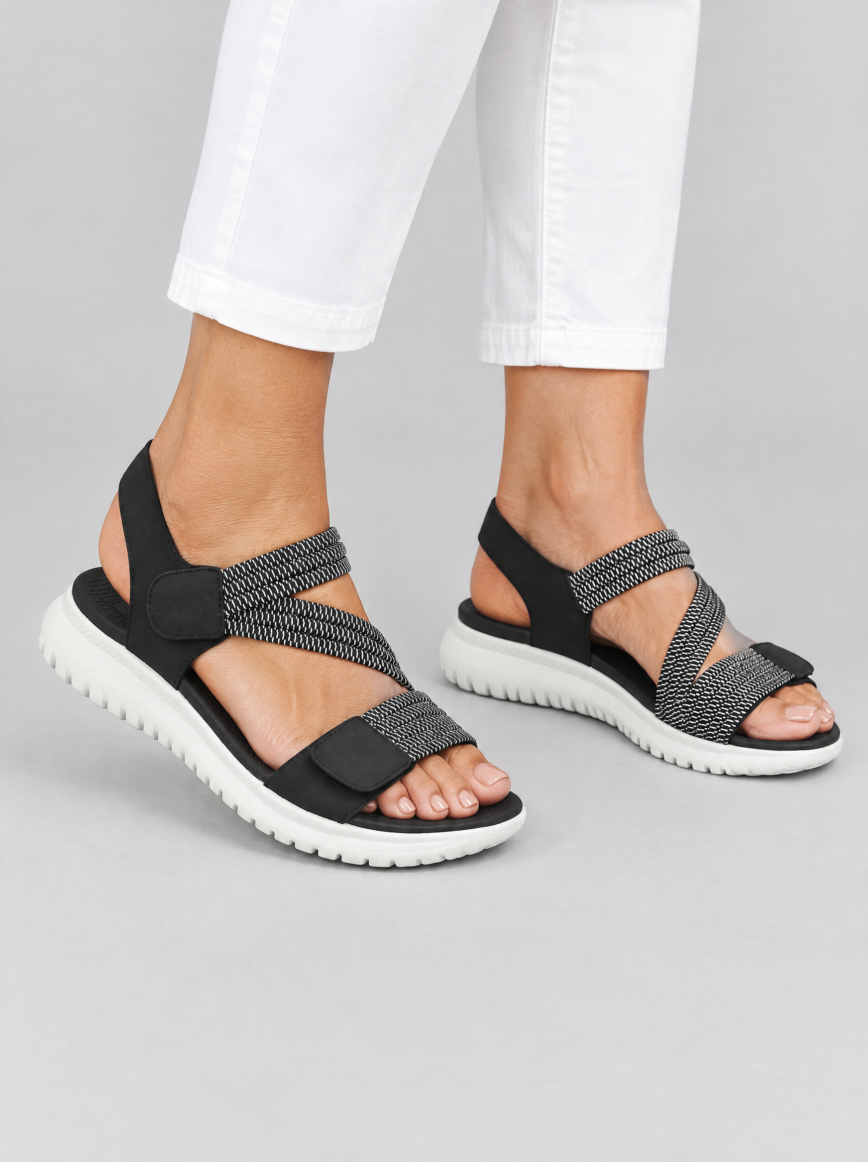 Finley sandals in black, worn with slim white cropped trousers