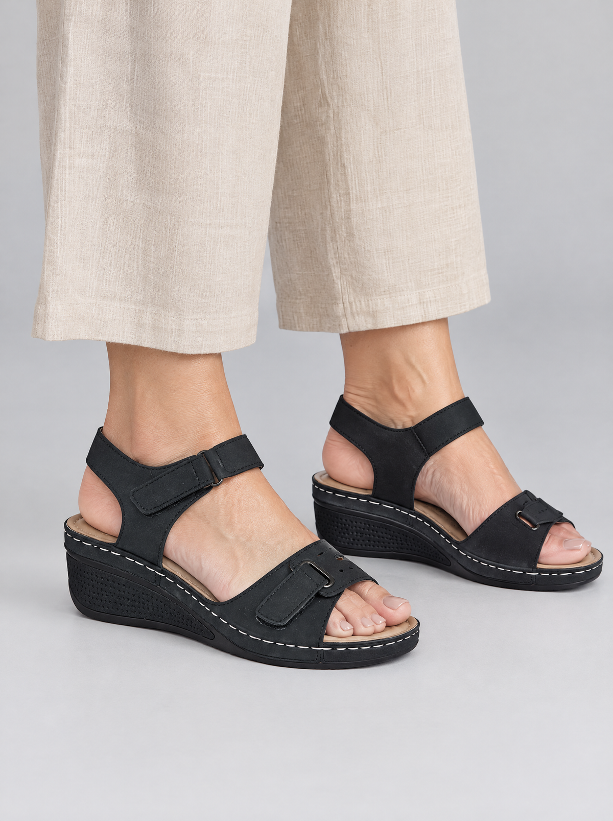 Helene sandals in black, worn with neat beige linen wide leg trousers