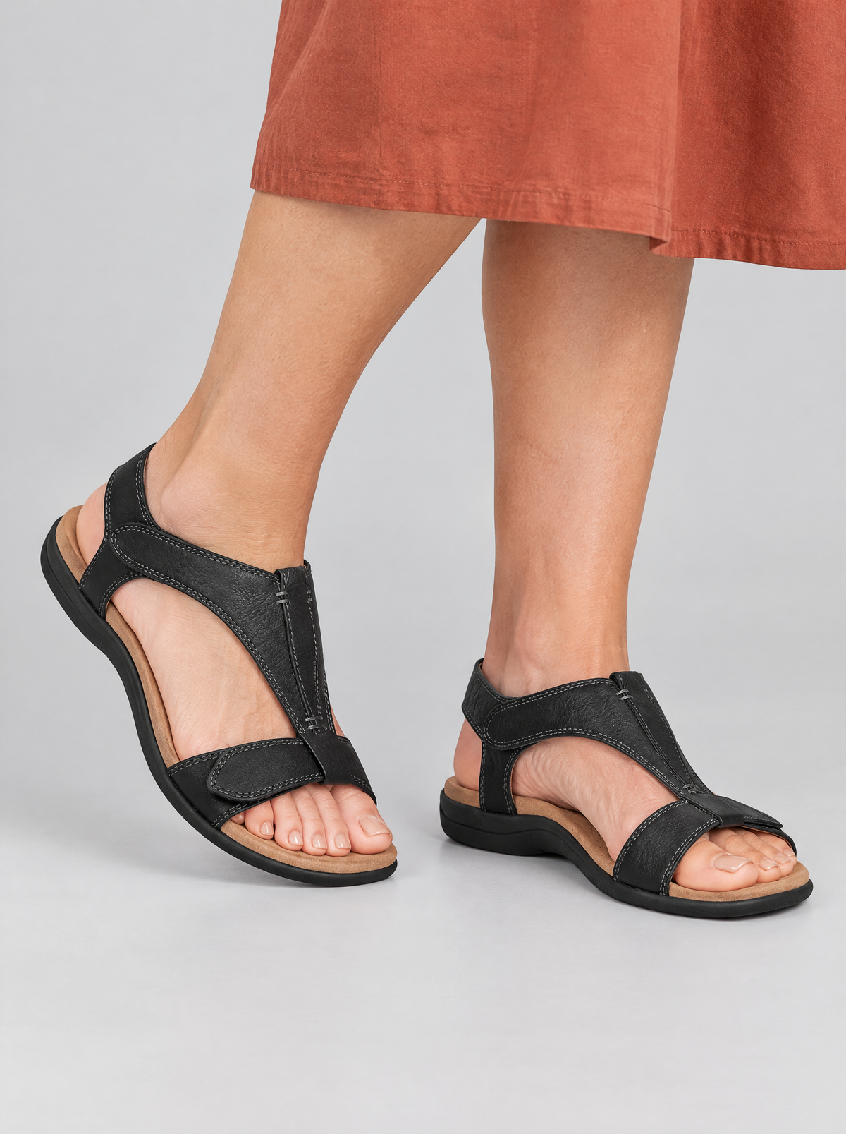 Finola sandals in black, worn with a terracotta cotton midi dress