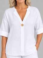 Zamma linen V neck top in white, close up of neckline and wooden button